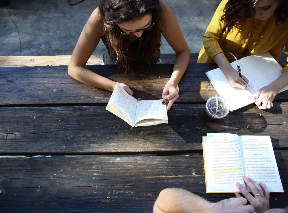 banner, students studying at picnic table shot overhead